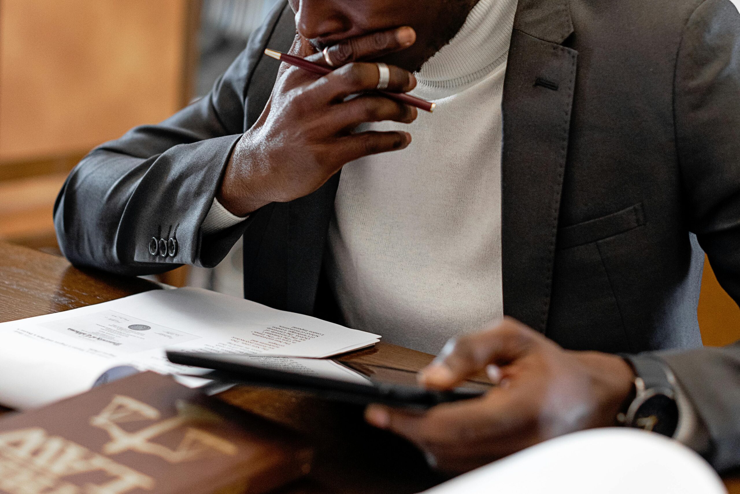 Focused businessman reviewing documents in a modern office setting.