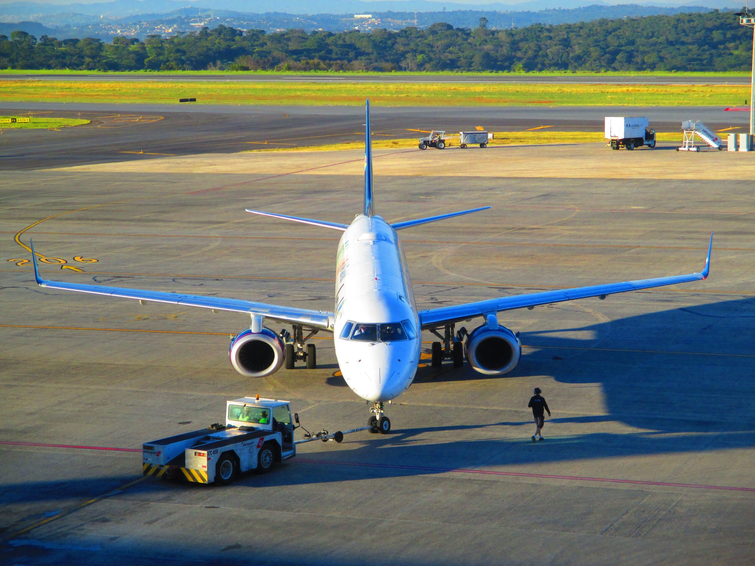 Jetliner preparing for takeoff at Belo Horizonte Airport in Minas Gerais, Brazil. Clear day, vibrant scene.